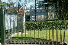 Green gate with scrolls